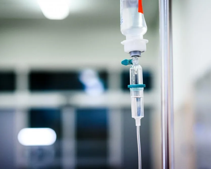 IV infusion bags hanging in a clinical treatment room